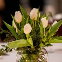 Beautiful center pieces for the tables with white flowers and candles